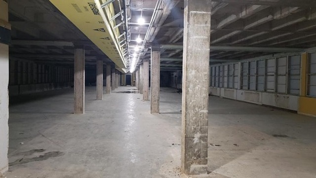 Open concrete basement level before renovation