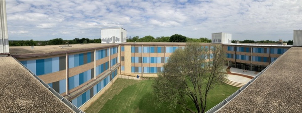 Panoramic view of a renovated school-style building and courtyard